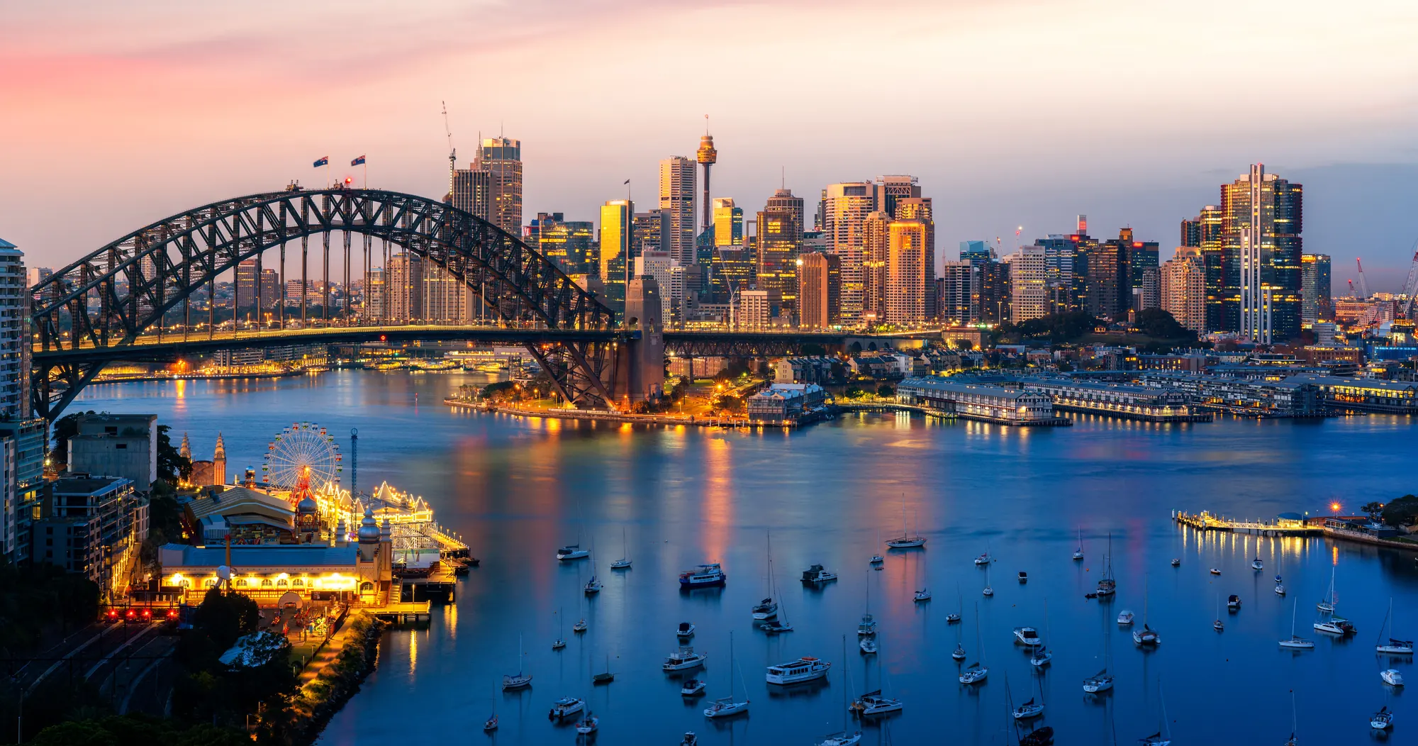 Sydney Harbour Bridge and the CBD skyline at dusk